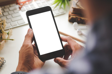 Cropped shot view of man hands holding smart phone with blank copy space screen for your text message or information content, female reading text message on cell telephone during in urban setting. 