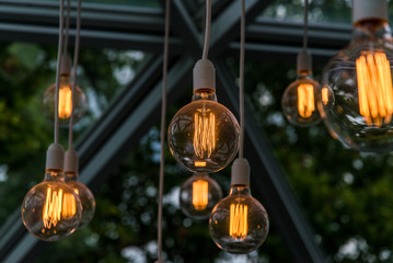 Vintage antique hanging light bulbs. Holidays and business good idea concept.