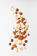 Flying nuts on a grey background: almonds, cashew and hazelnat - obrazy, fototapety, plakaty