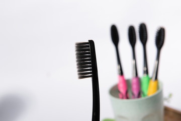 Put the toothbrush and oral cleaner on the white table.