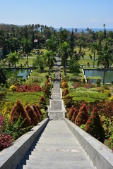 Vertical view of parks of Ujung Water Palace in Bali from top of steep stairs.