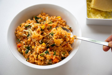 Risotto with tomatoes, fresh herbs and parmesan cheese