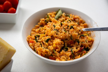 Risotto with tomatoes, fresh herbs and parmesan cheese