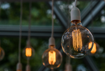 Vintage antique hanging light bulbs. Holidays and business good idea concept.