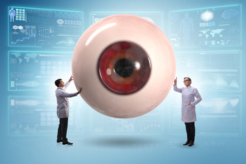 Doctor examining giant eye in medical concept