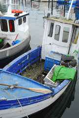 Fototapeta na wymiar one small fishing boat lies in a Baltic Sea port