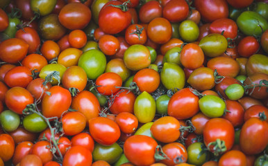 Fresh tomatoes on a market counter.