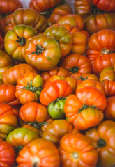 Fresh tomatoes on a market counter.