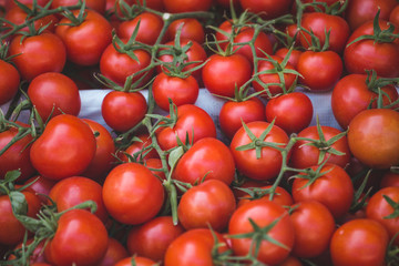 Fresh tomatoes on a market counter.