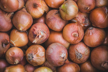 Onions on a market counter.