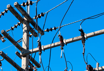 High voltage electric pole and transmission lines with clear blue sky. Electricity pylon. Power and...