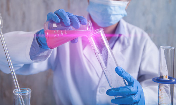 Girl Working With Flasks In A Laboratory.