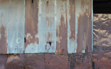 The surface of an old metal wall with many forms of dilapidating rust