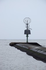 Wind-gauge and solar panels at Vistula mouth's breakwater