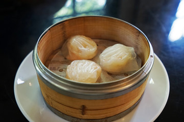 Ha Gao Dim sum (Chinese prawn dumplings served in steamed wooden basket container)