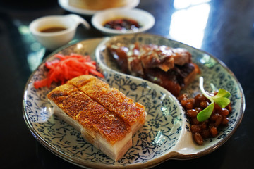Close up Roasted honey duck served with crispy barbecue pork