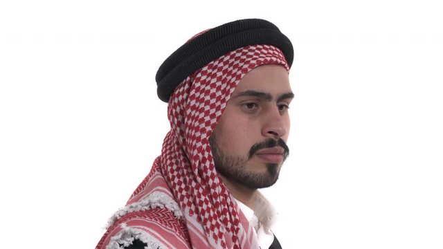 Back view of Arab man wearing traditional Saudi clothes (shemagh). Male model is turning to camera and smiling. Isolated, on white background