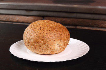 Graham bread roll on paper plate