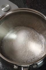 Fototapeta na wymiar Add sugar into pan. Making Golden Syrup Series.