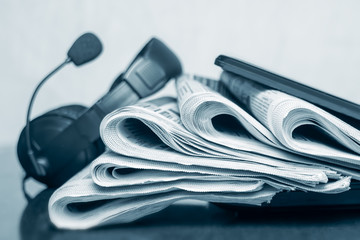 Newspapers on the desktop in the office, media concept