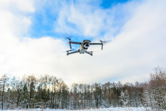 A quadcopter with a built-in camera flies into the sky, captures video footage of the photo.