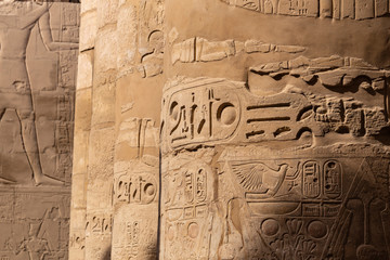 Karnak Temple, complex of Amun-Re. Great Hypostyle Hall. Embossed hieroglyphics on columns and walls. Luxor Governorate, Egypt.