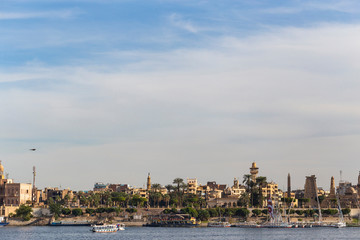 Fototapeta na wymiar Luxor, Egypt, Karnak Temple, complex of Amun-Re. View of the ancient city of Thebes from the Nile. Panoramic city, view from the river.