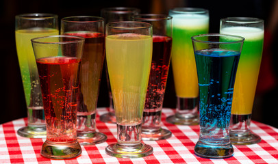 Glasses with a cocktail. Multicolored drinks. Drunk party.