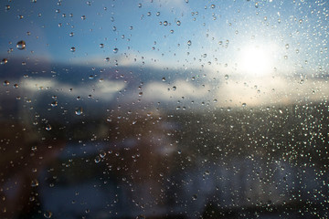 wet window after rain on the background of the rising sun. beautiful spring weather