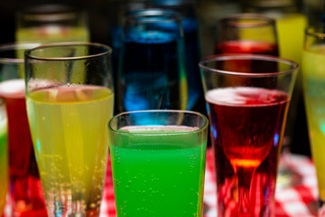 Glasses with a cocktail. Multicolored drinks. Drunk party.