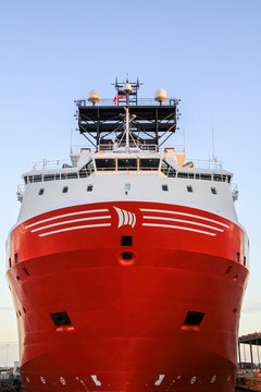 Red offshore vessel high and dry at the yard.