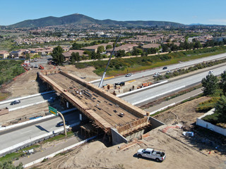 Aerial view of bridge construction crossing the highway, California, USA