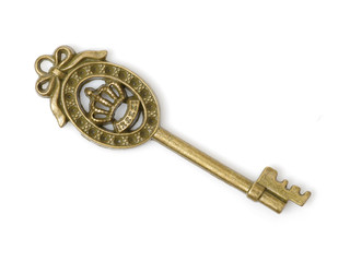 old brass key against a white background
