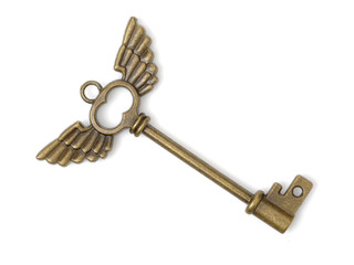 old brass key against a white background