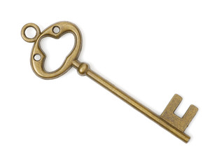 old brass key against a white background