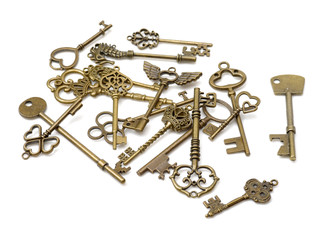 old brass key against a white background