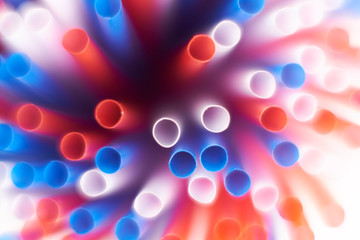 Colored cocktail plastic drinking straws rotates on white color background.