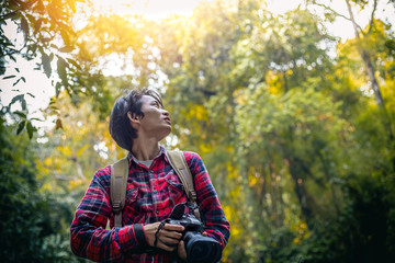 Tourists man holding camera in forest
