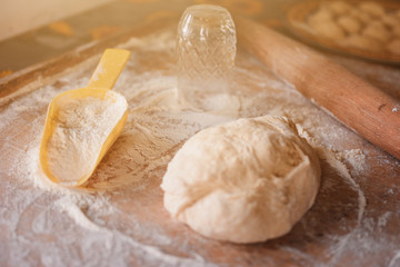 Cooking dumplings at home, dough and flour with dumplings on a wooden board.2020