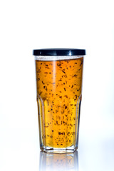 Pineapple jelly in a glass with a lid on a white background.