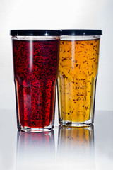 Raspberry jelly in a glass with a lid on a white background.