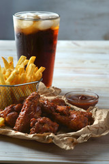 grilled BBQ wings with French fries and Cola