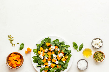 Cooking salad with pumpkin and basil. Ingredients on white background top-down copy space