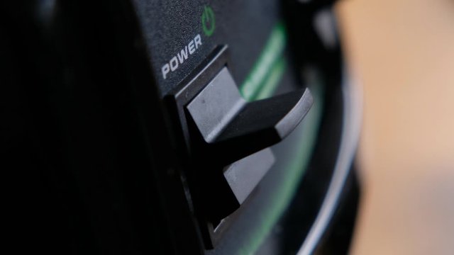 Woman turn switch on the power button on an electrical device