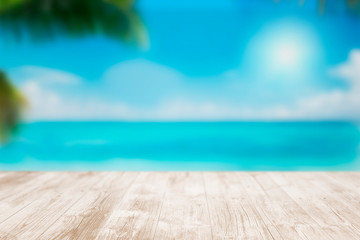 Empty wooden terrace on the beach with blurred water and sky. Close-up view with selective focus.