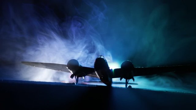German night bomber at night. Artwork decoration with scale model of jet-propelled plane in possession. Toned foggy background with light. War scene. Selective focus