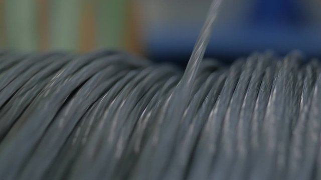 Winding cable on a rotating coil. Production of electric cable.