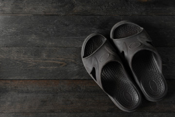Rubber sandal with softness on wooden table.