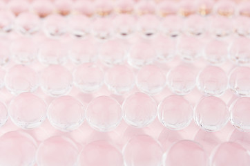 Abstract elegant gentle festive pink background with transparent glass balls, texture, blur.