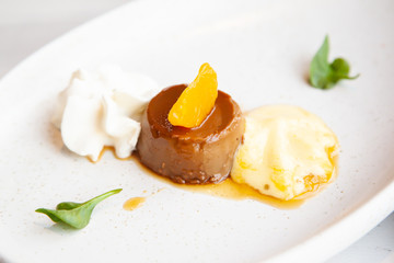 Coffee pudding served with whipped cream and passion fruit mousse